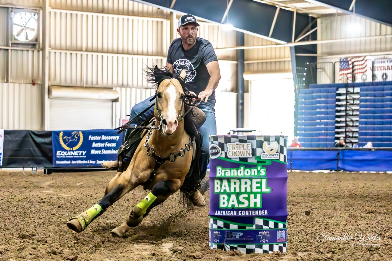 Man in Derby Days shirt on buckskin horse rounding Brandon's Barrel Bash drum