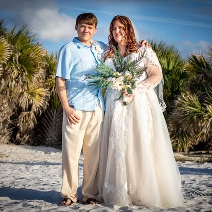 Couple portrait on the beach with palm trees