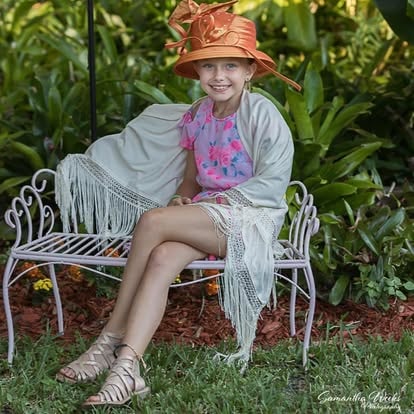 Girl sitting in garden chair smiling