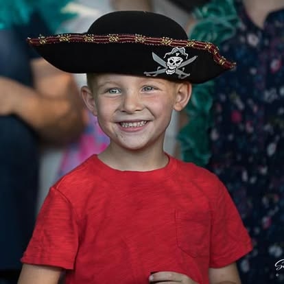 Smiling child wearing pirate hat