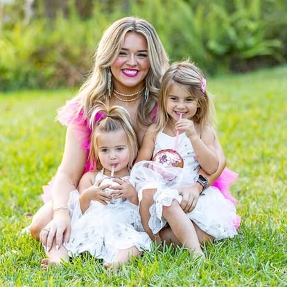 Woman with two young girls on grass