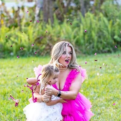 Woman and child blowing bubbles in outdoor garden