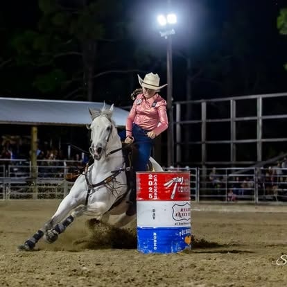 Barrel racer rounding a barrel at full speed