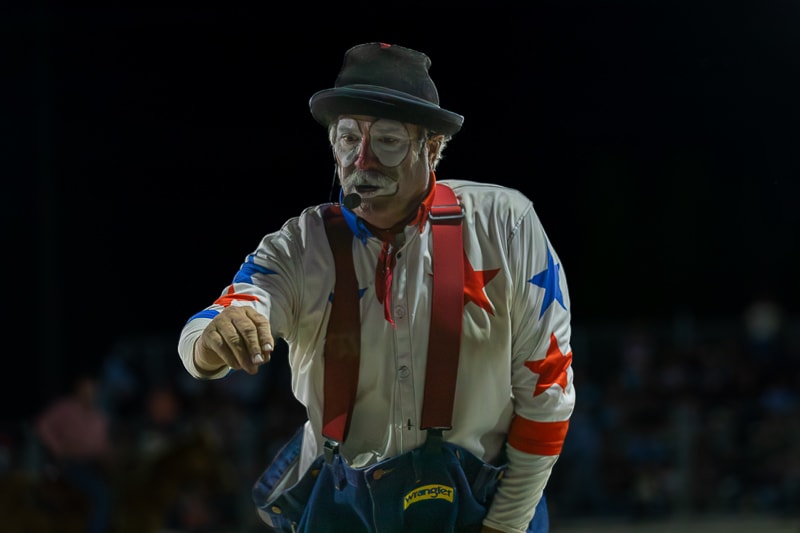 Rodeo clown in Wrangler costume performing in arena at Cracker Day Rodeo