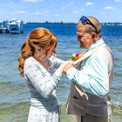 Couple exchanging rings beach ceremony