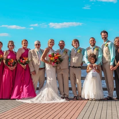 Wedding party posing on wooden dock