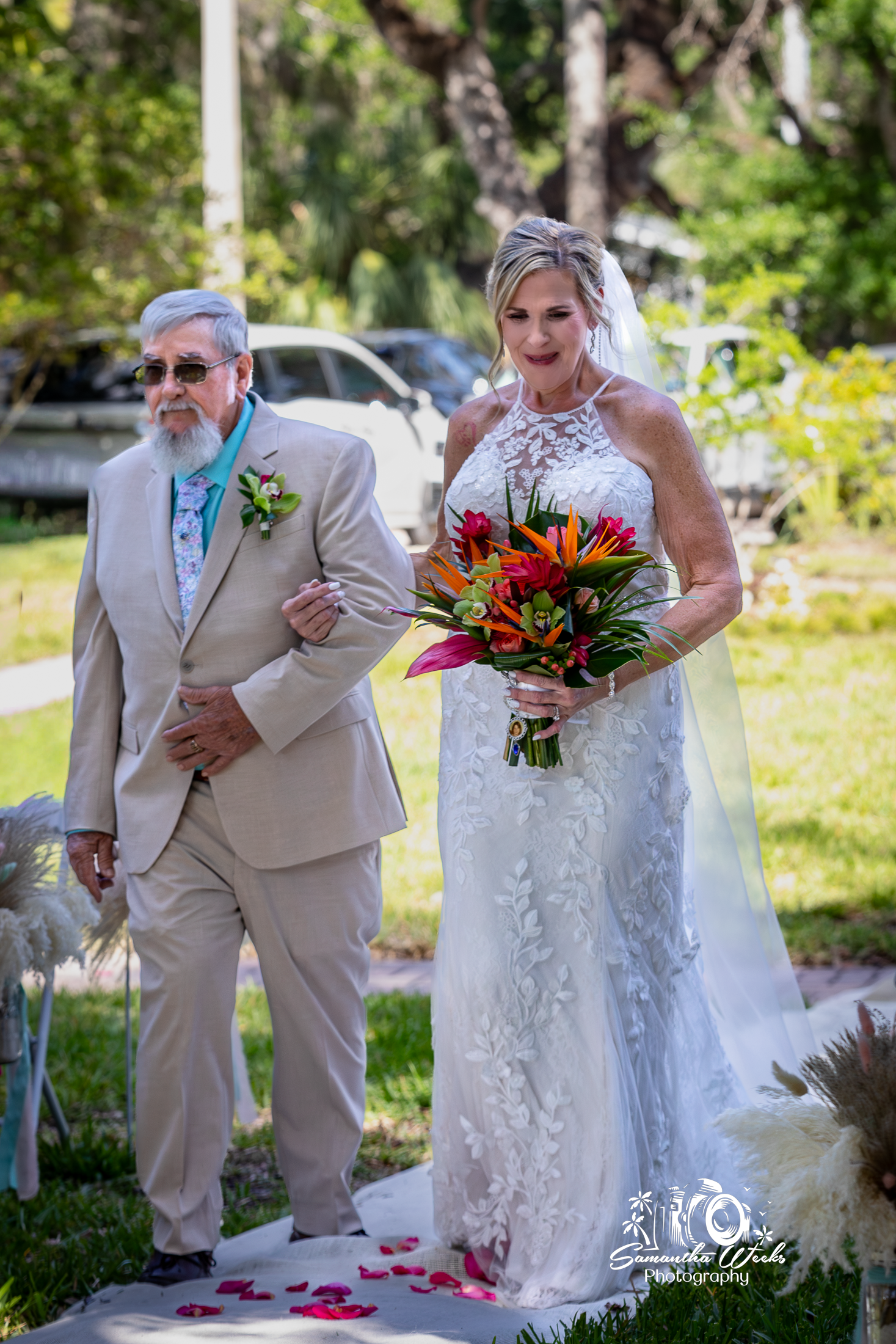 Bride walking with father outdoor wedding ceremony
