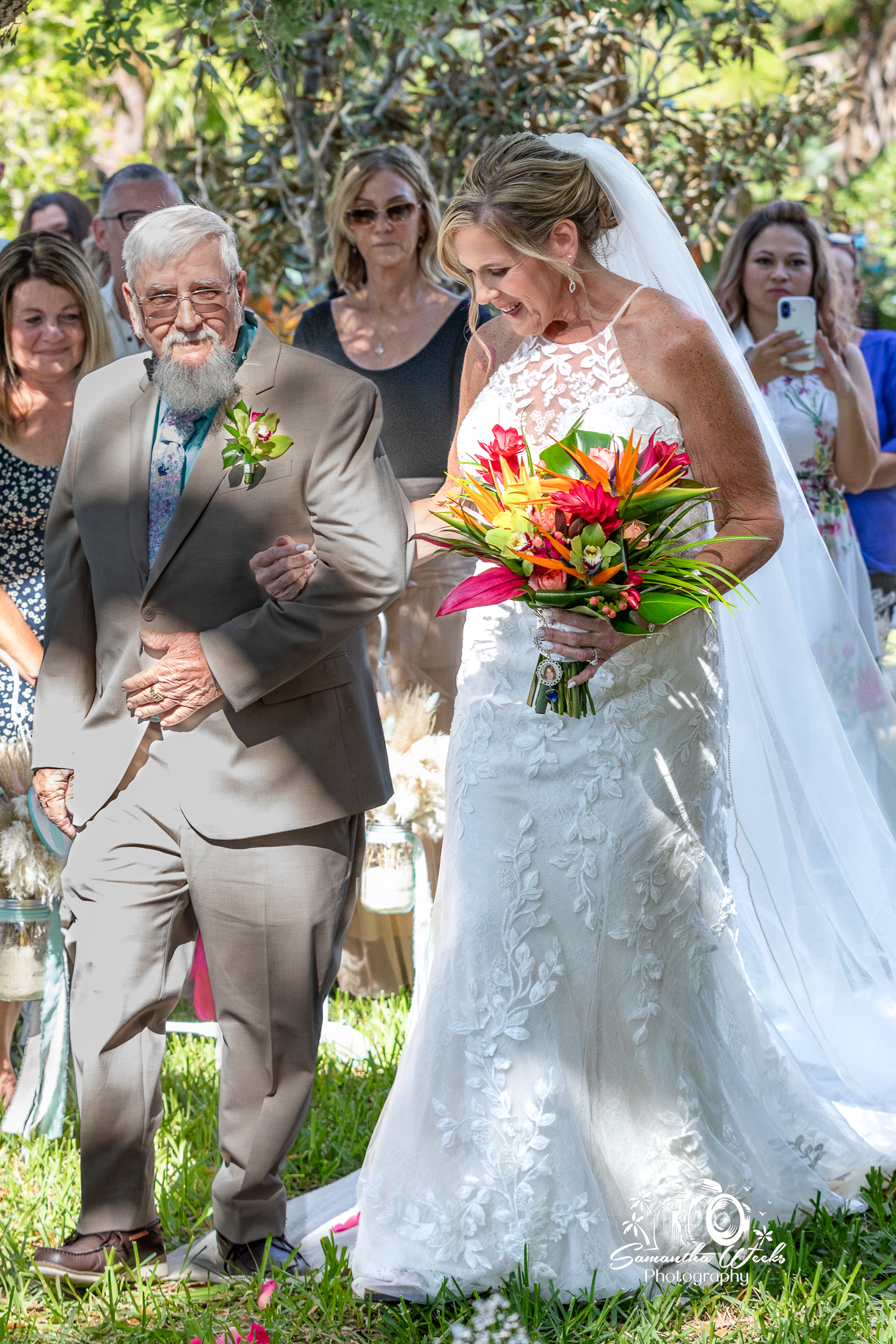 Bride walking with father outdoor wedding ceremony