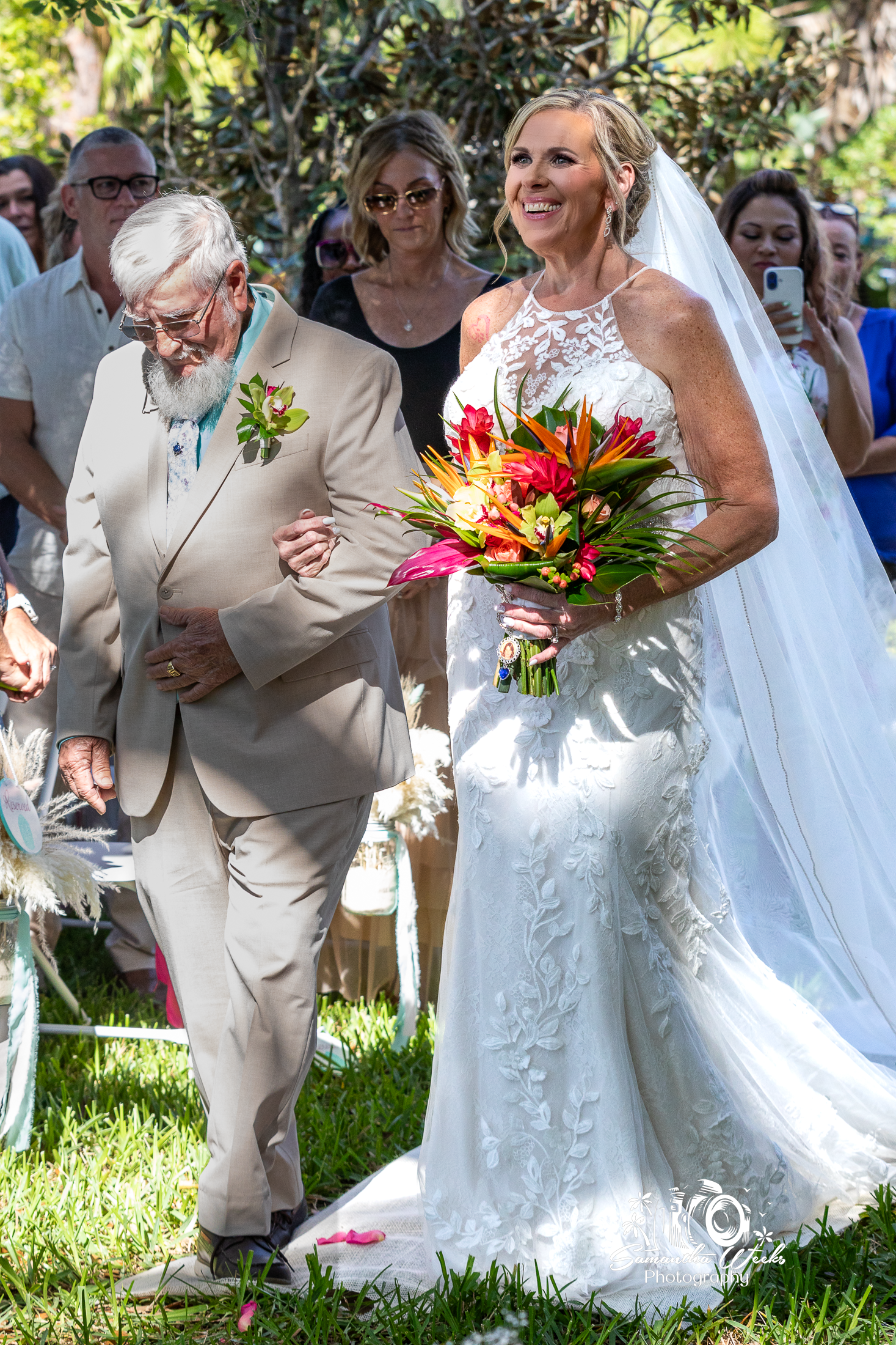 Bride walking with father outdoor wedding ceremony