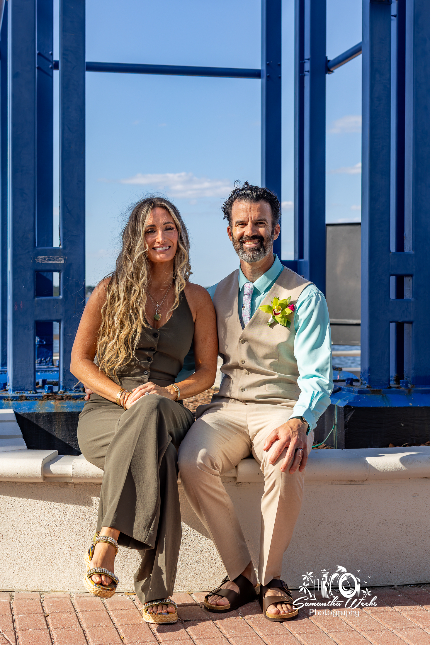 Couple posing at industrial blue structure